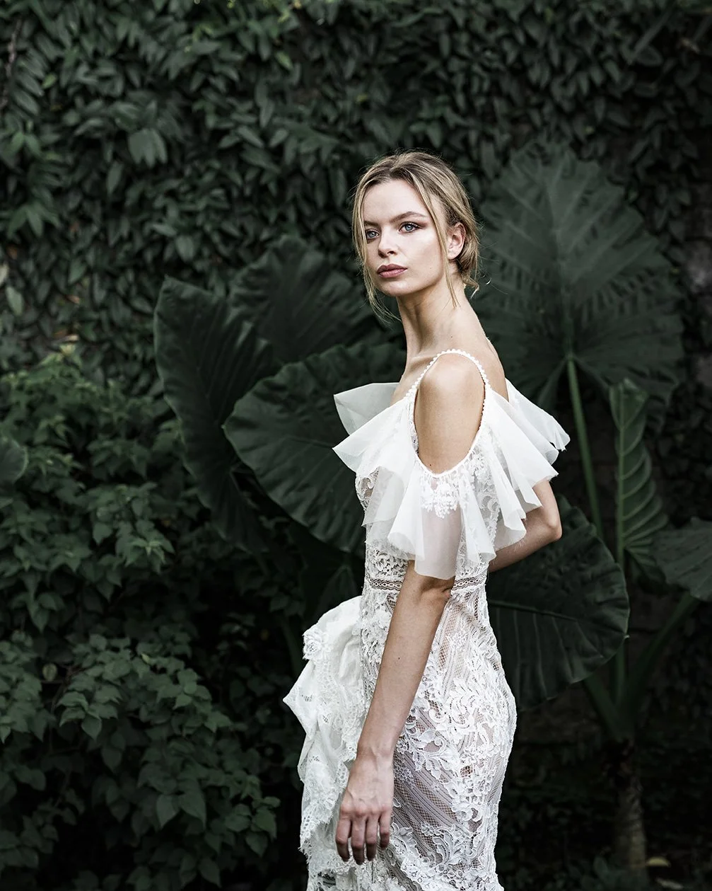 Woman wearing a full lace fit and flare wedding dress "Mia" by Atelier Edwin Oudshoorn