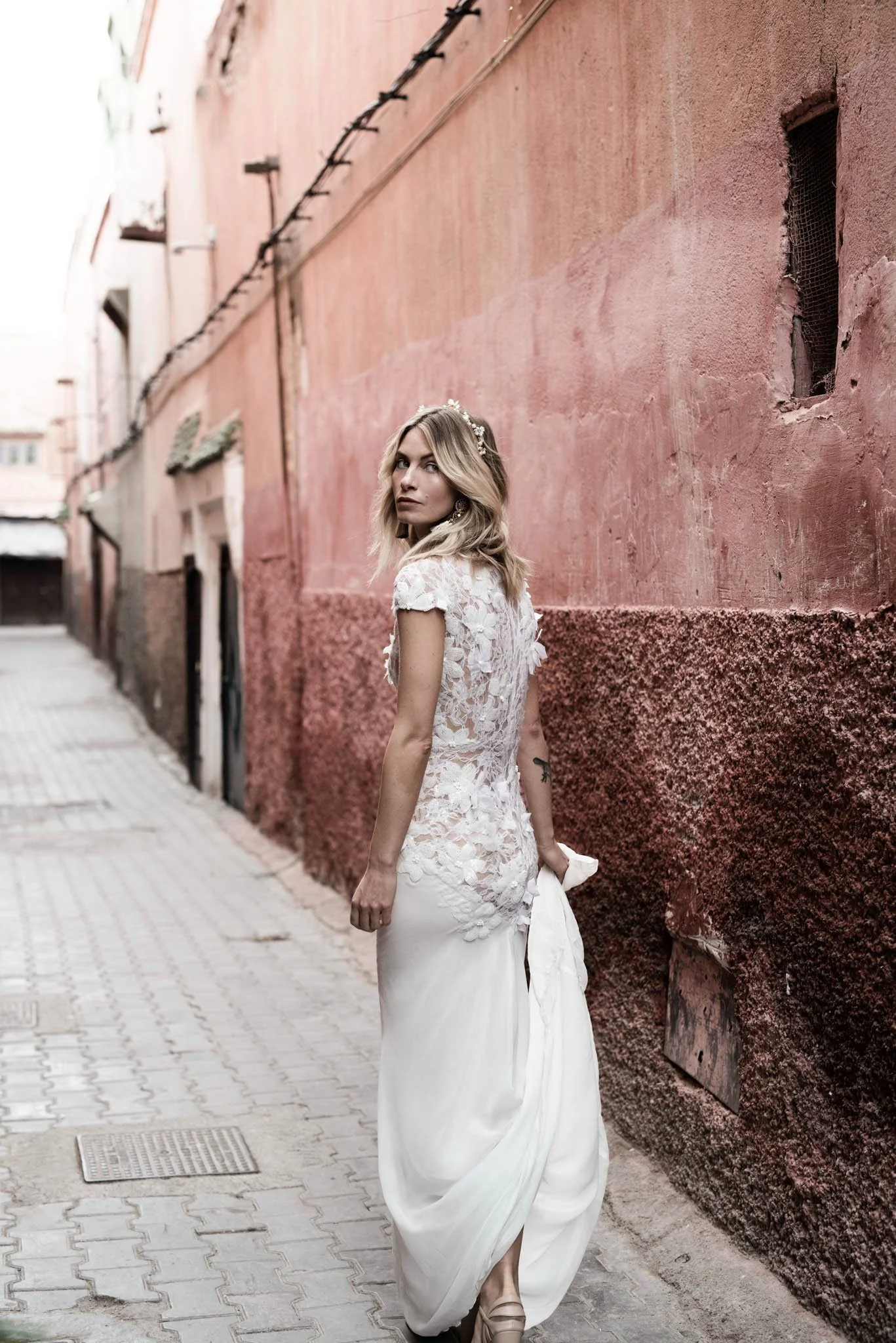 Bride wears delicate silk wedding dress with hand embroidered lace details "Lotte" by Atelier Edwin Oudshoorn