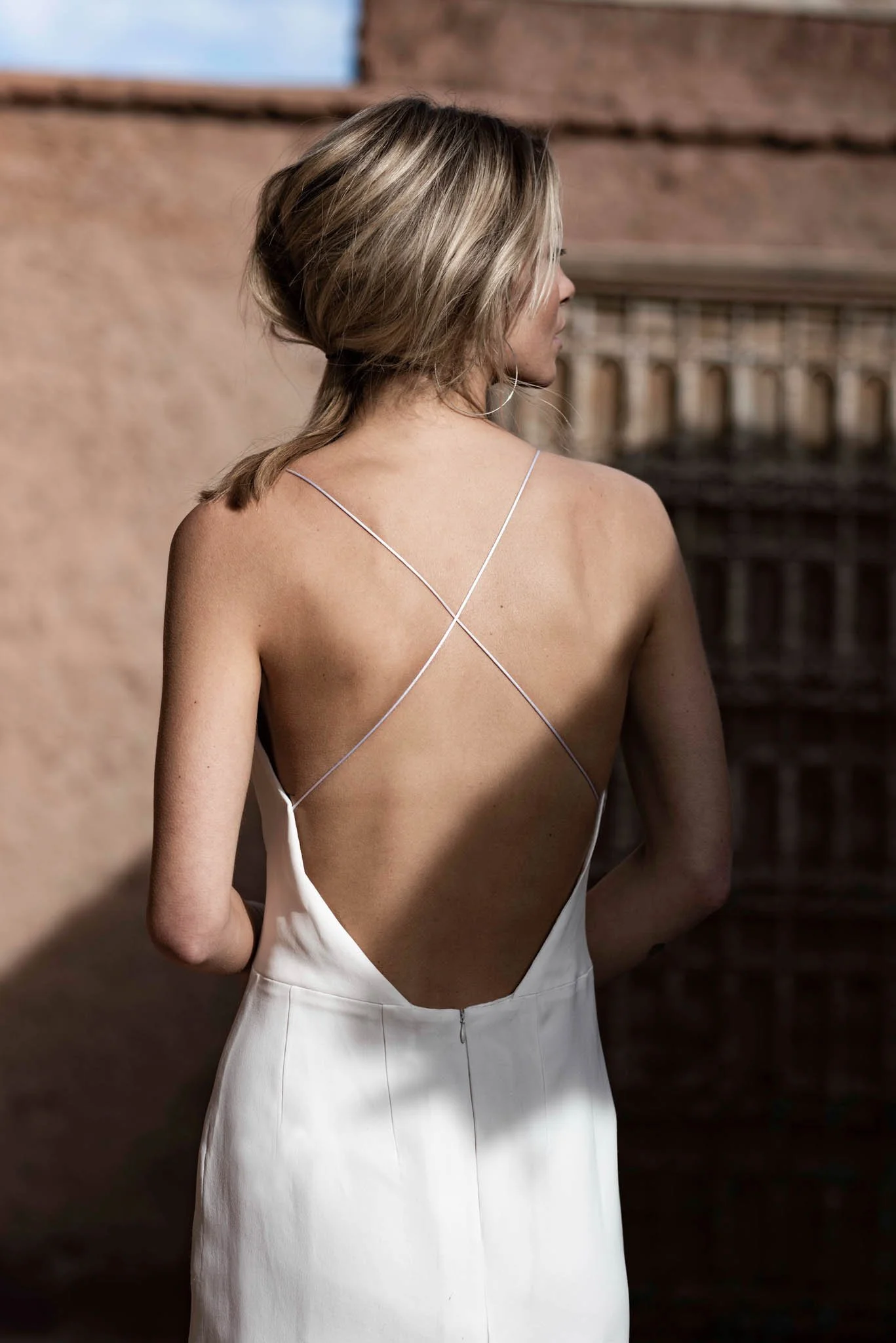 Bride wears crepe slip dress with high split and deep open back  "Sophie" by Atelier Edwin Oudshoorn