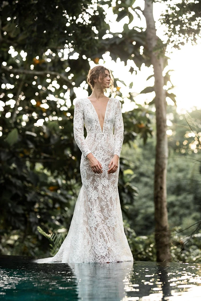Woman wearing full lace wedding dress with long sleeves "Harper" by Edwin Oudshoorn