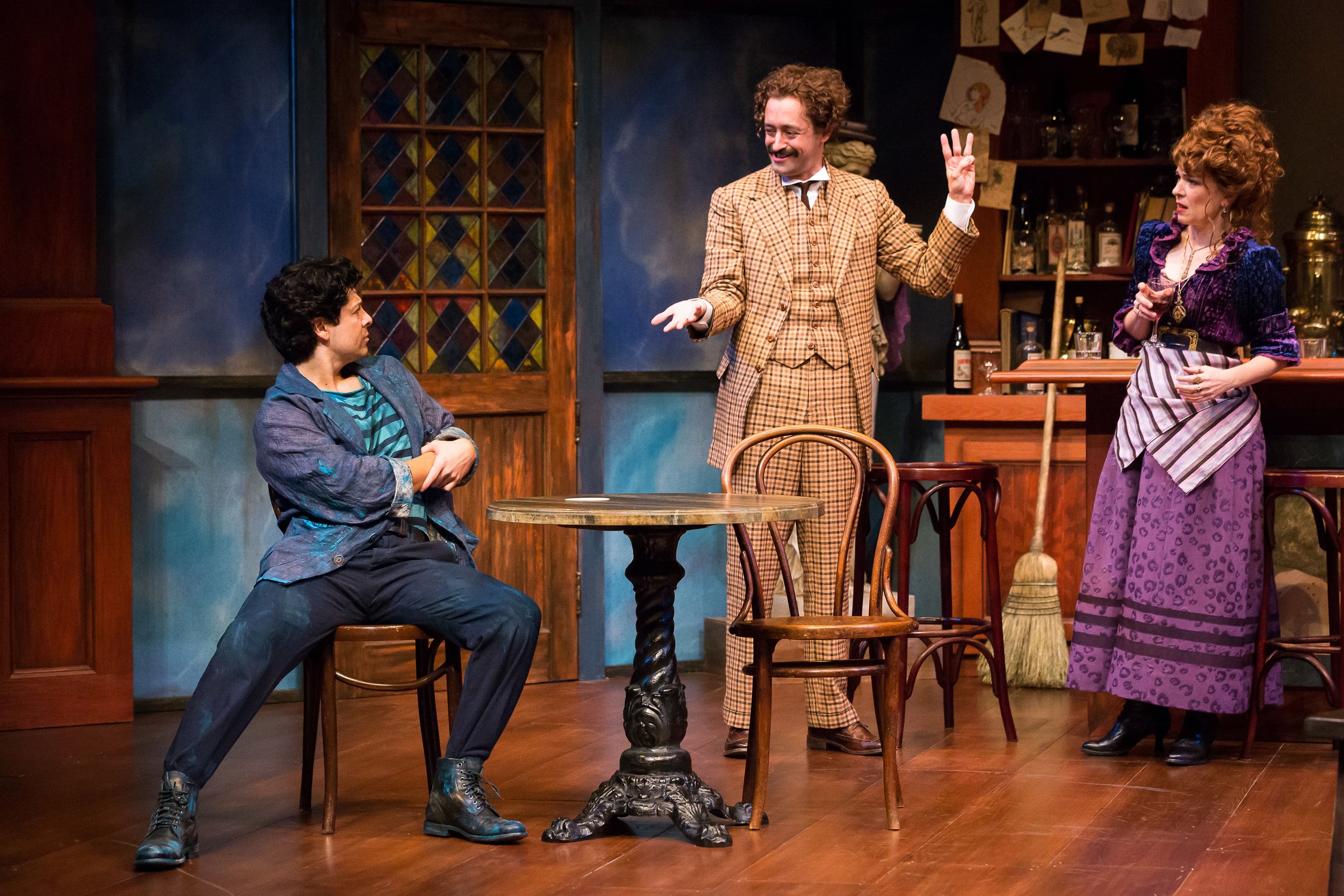 Joseph Castillo-Midyett as Pablo Picasso, Dylan Godwin as Albert Einstein, and Elizabeth Bunch as Germaine in the Alley Theatre’s production of Picasso at the Lapin Agile by Steve Martin. Directed by Sanford Robbins. Photo by Lynn Lane.