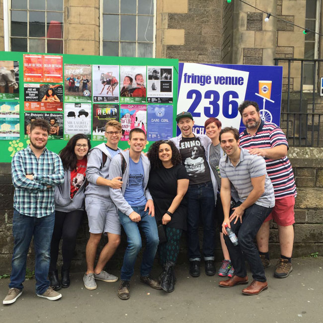 The Dani Girl Fringe Team outside Greenside Infirmary Square with our poster alongside the rest of the Greenside shows.
