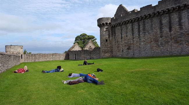 The Dani Girl Team napping outside of Craigmillar Castle.