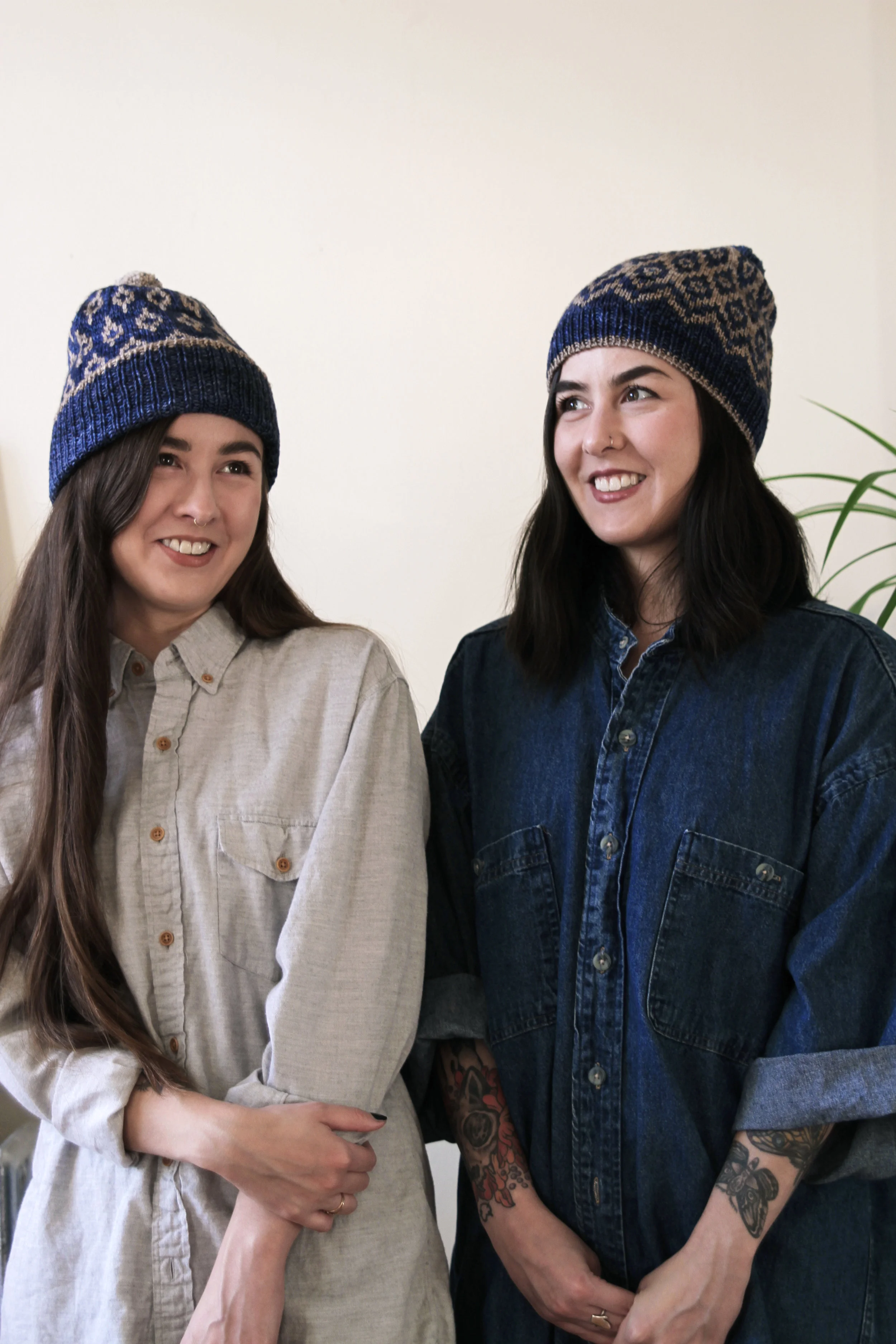 Half Japanese twin women wearing hand knit toques.