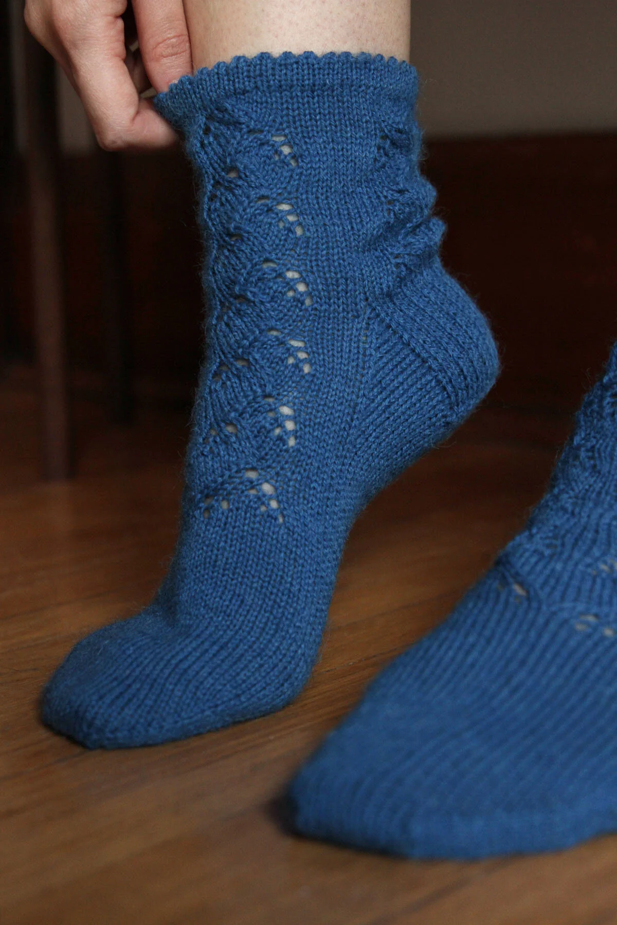 Woman’s feet showing osakajo socks being pulled on.