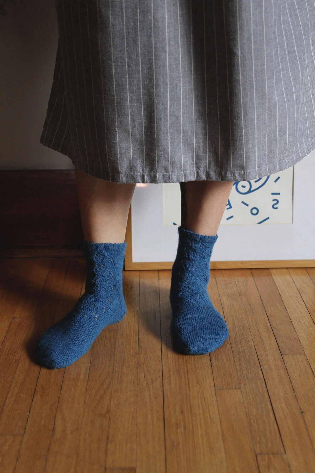 A woman in a grey skirt wearing the osakajo socks.