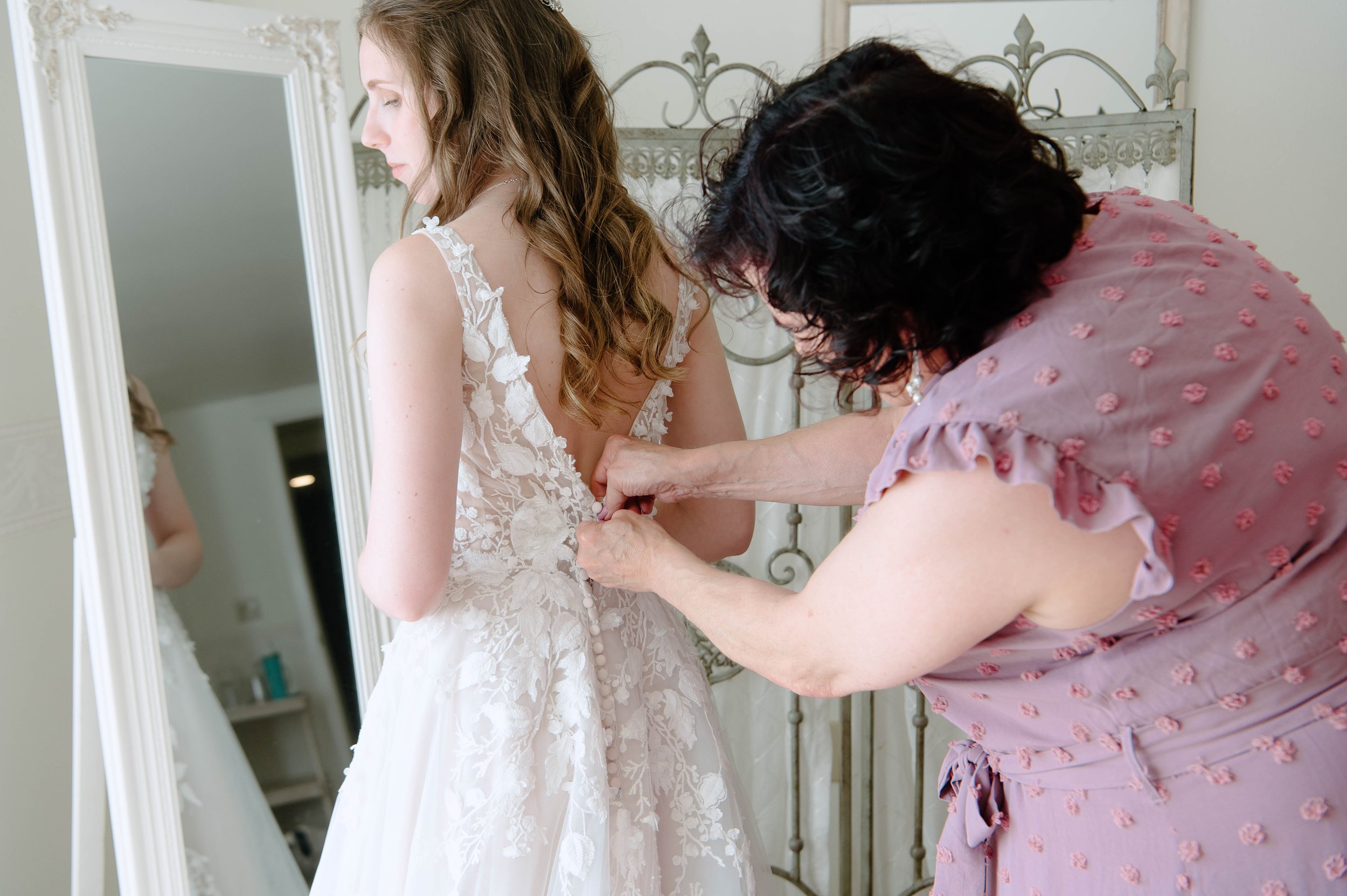  Mother of the Bride helping the Bride into her Wedding Dress 
