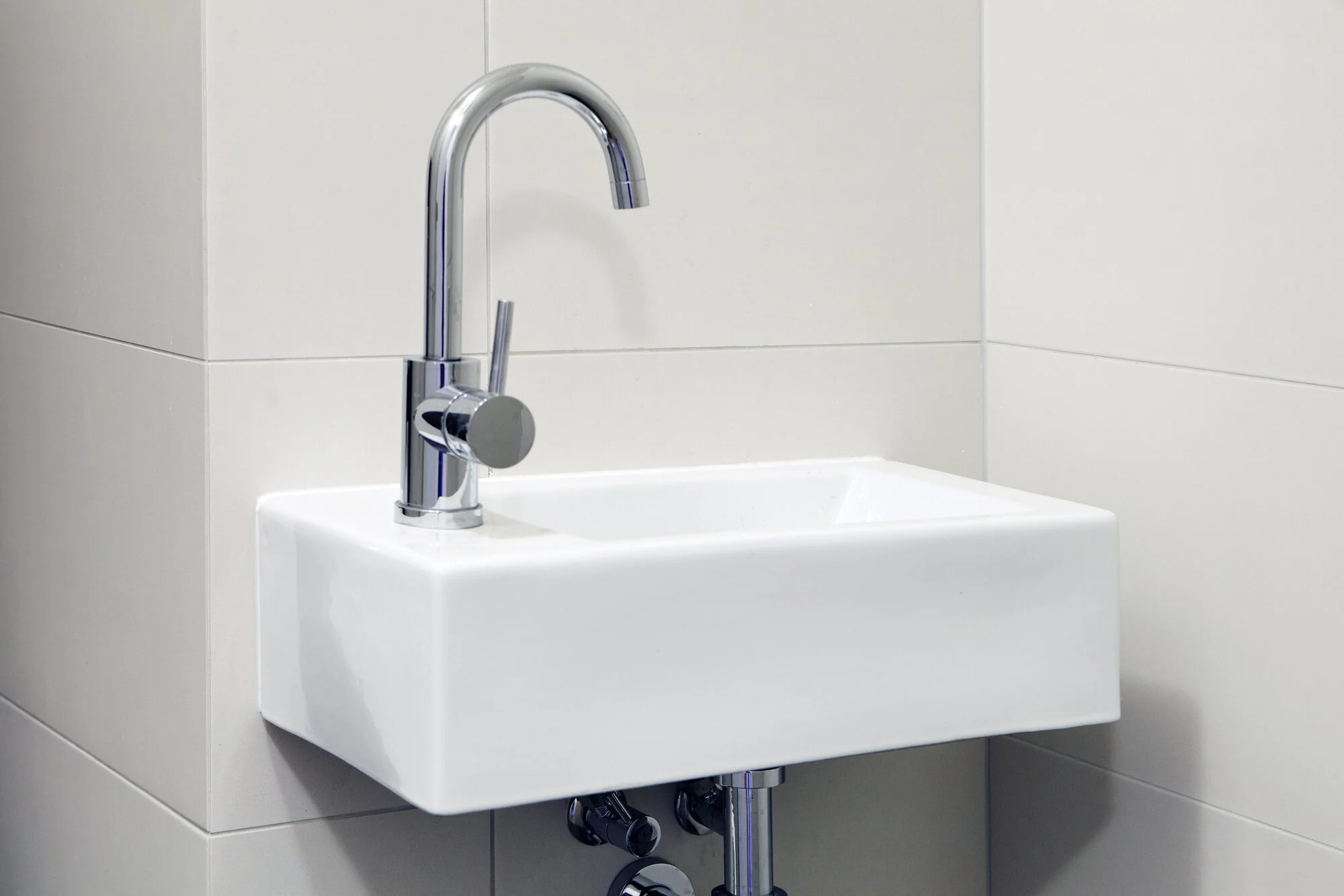 Modern wall-hung sink designed for a compact powder room or small bathroom renovation