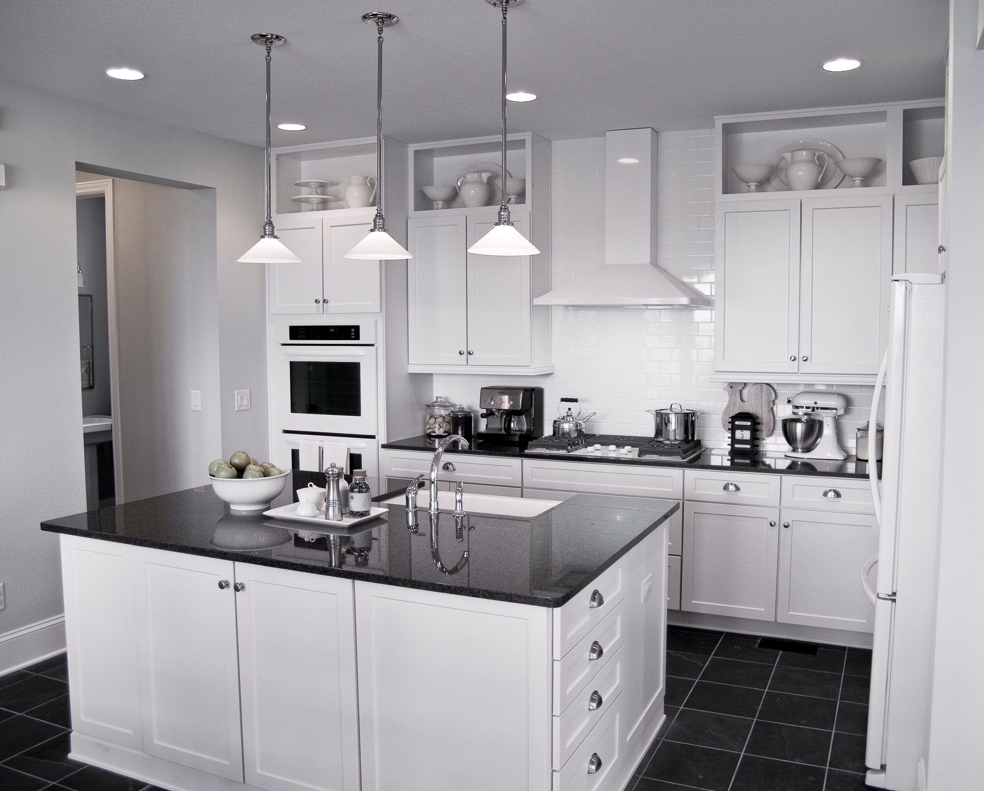 Another great example of a black and white kitchen with silver accessories!