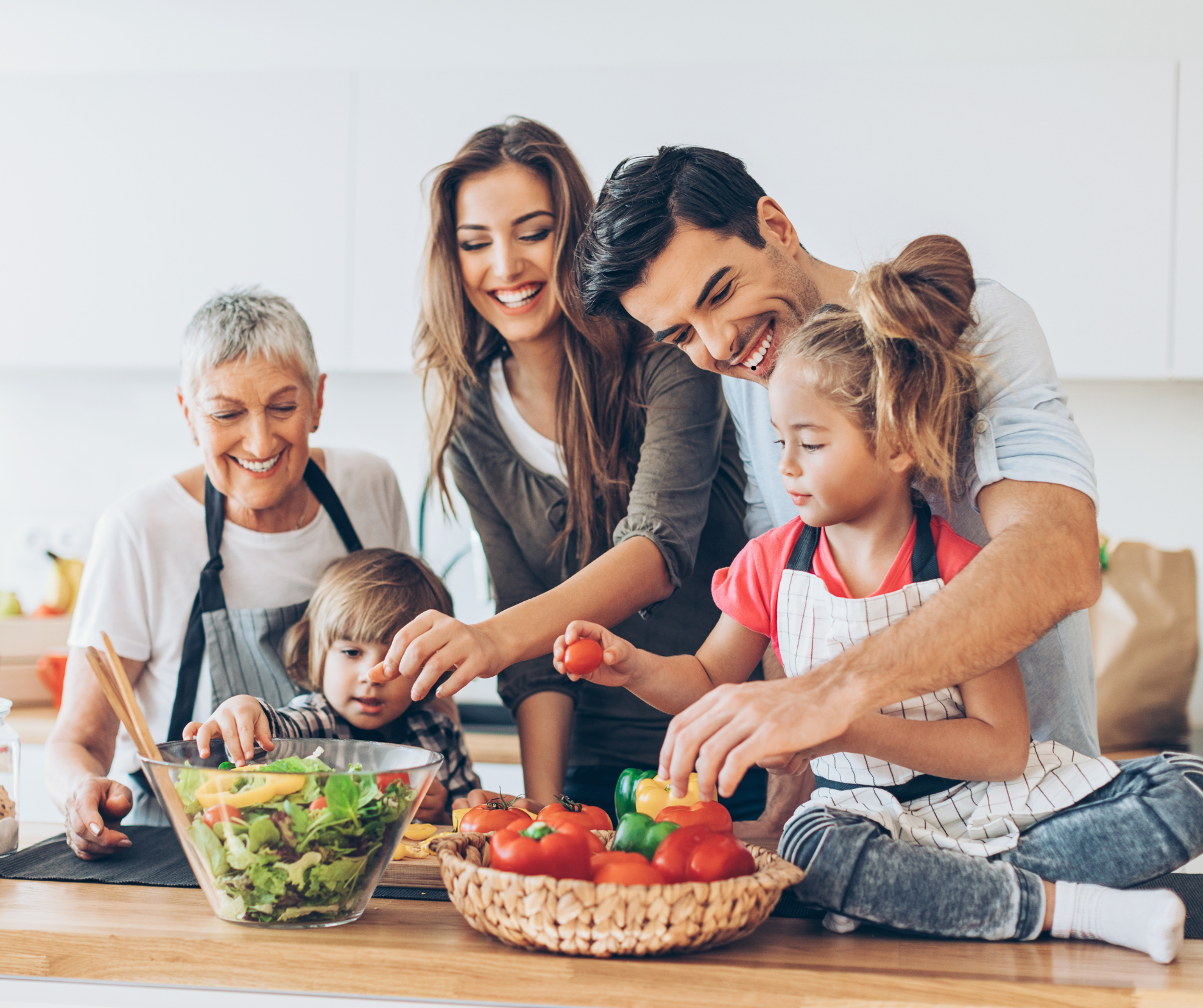 Happy family all together preparing a meal in their newly renovated kitchen.