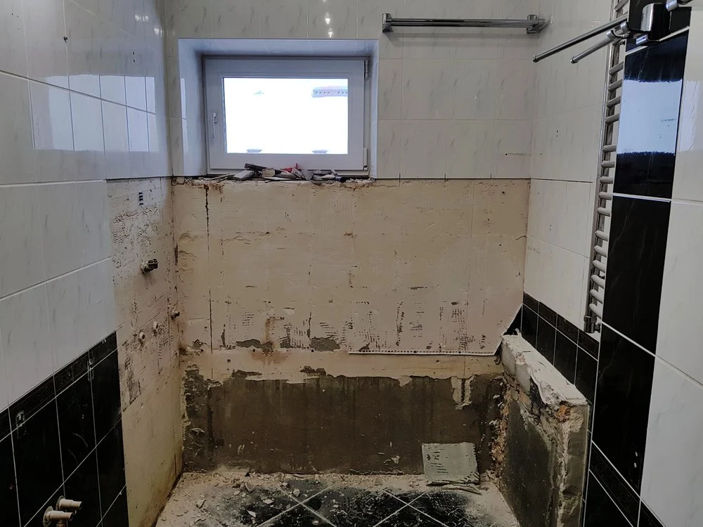 Bathroom shower walls opened during renovation revealing hidden moisture damage