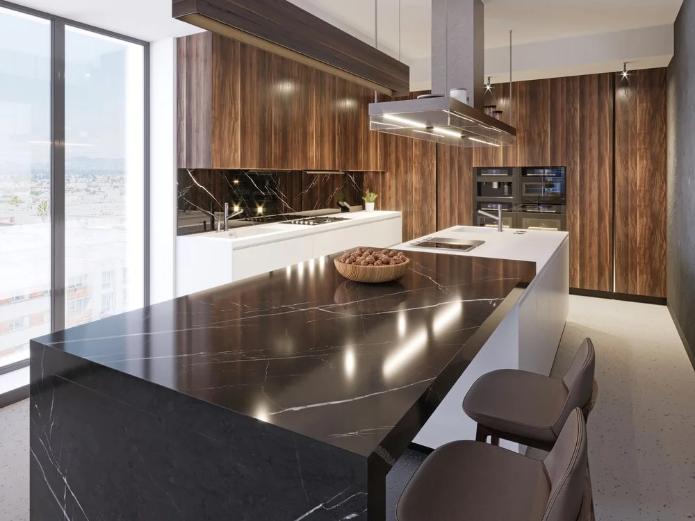 Modern kitchen featuring black stone waterfall island countertop with wood cabinetry and integrated appliances