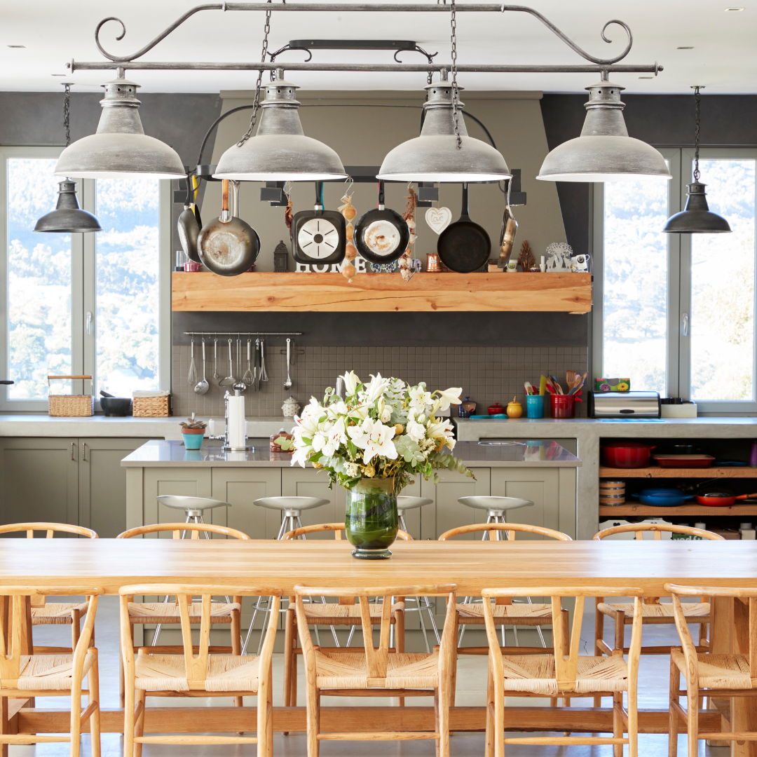 Updated kitchen with grey shaker style cabinets, quartz countertop and a working island.