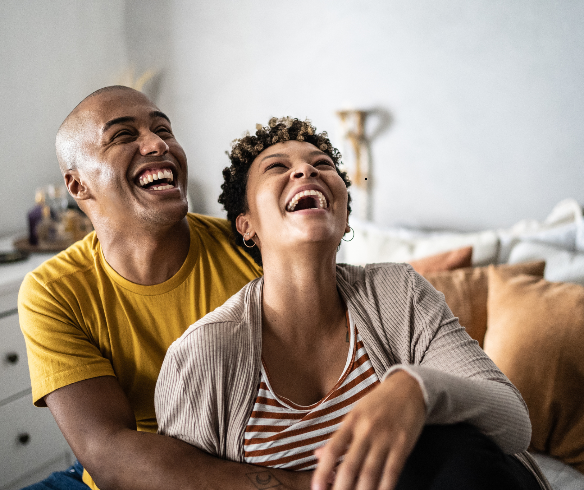 Smiling couple relaxing at home after their completed renovation in Durham Region.
