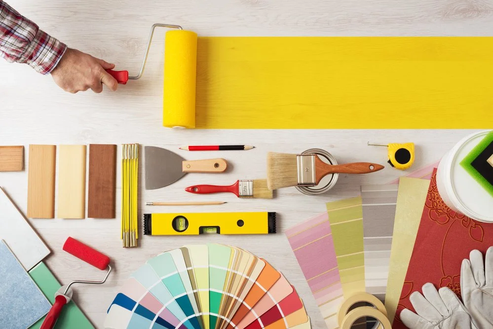 Home renovation tools, paint roller, and colour swatches representing the creative process in Durham Region.