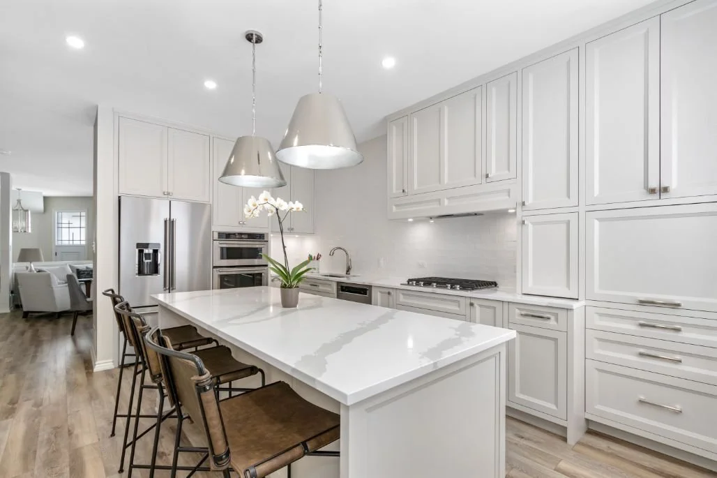 Modern open concept kitchen with Balboa Mist kitchen cabinets and quartz countertop.