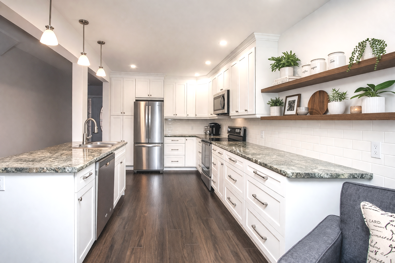 Modern white galley kitchen renovation with shaker cabinets, laminite countertops, subway tile backsplash, stainless steel appliances, and floating wood shelves for added storage and style.