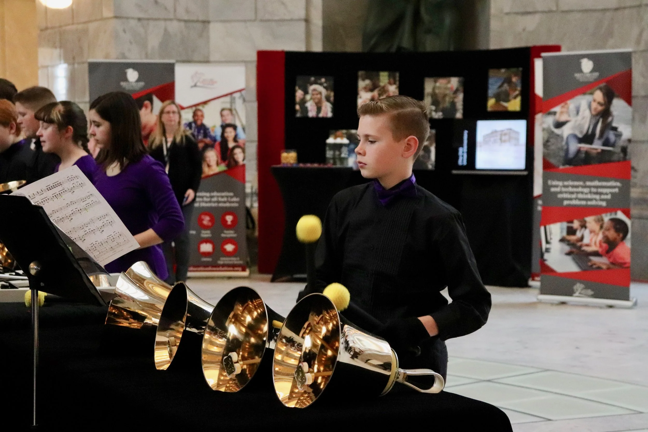 One young student waits for his time to shine on the bells.