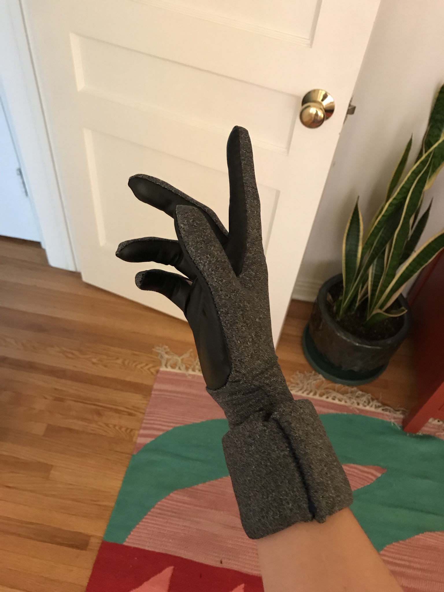The cuff on this glove was made from wrapping a piece of 2mm EVA foam inside of a bunch of layers of the stretch fabric I used on the gloves. Later I hid the seam with a simple piece of the same fabric. I think I would probably go about this a diffe