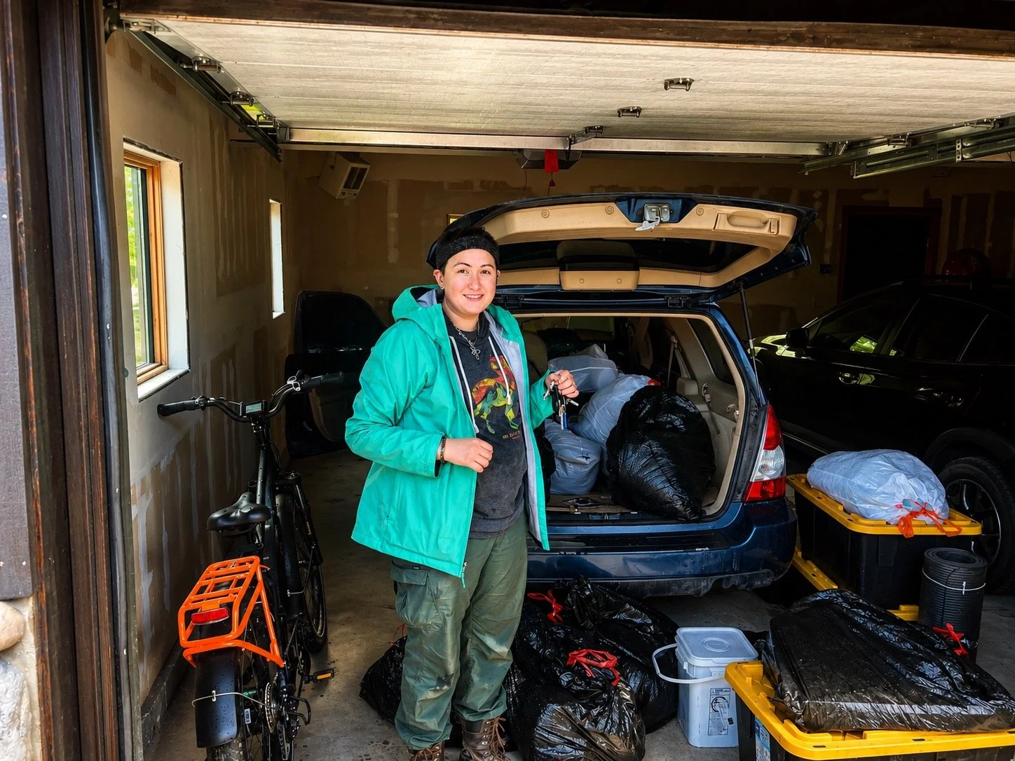 Chef Alayah smiling in the garage of her new downtown Jackson Hole condo during move-in — Snake River Grill, Jackson Wyoming