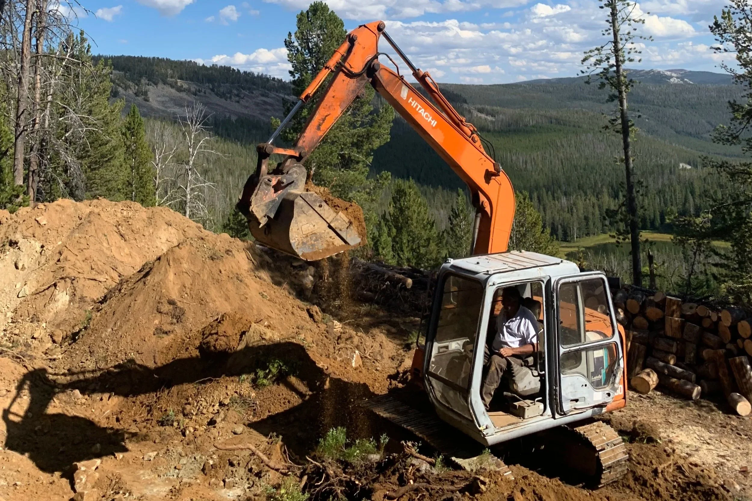 Brandon excavating the Elev8150 lodge building pad — Anaconda, Montana