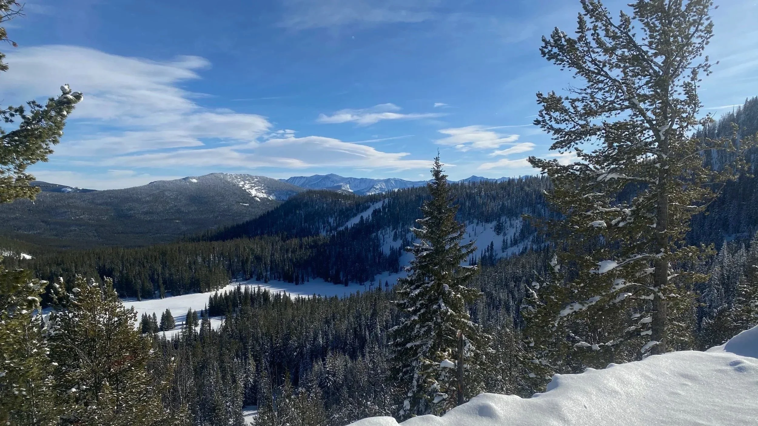 Showers Lake frozen in winter with Pintler Peaks and blue sky — view from Elev8150 at 8,150 feet, Anaconda Montana