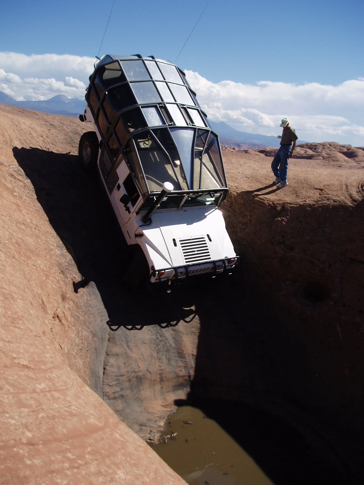 Brandon Bellrose driving his self-built guide Hummer on Hells Revenge trail, Moab Utah — Hummer Extreme Adventures