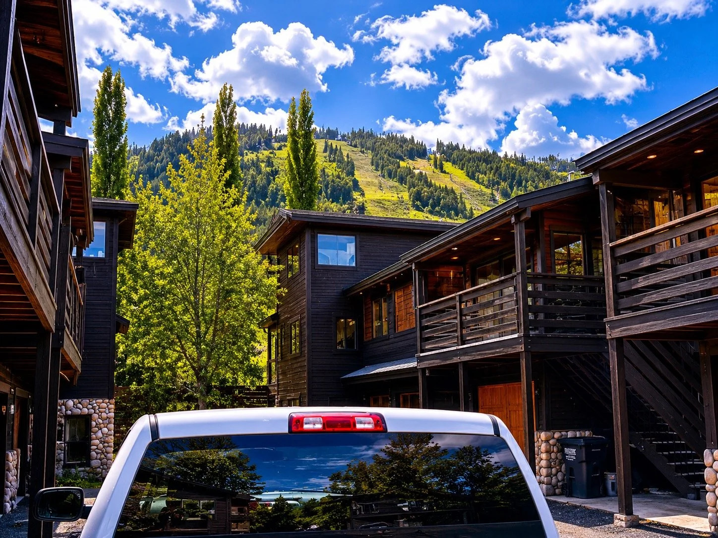 View over the Elev8150 Dodge truck and the rooftop of Alayah's condo showing Snow King Ski Resort directly behind — one block away in downtown Jackson Hole