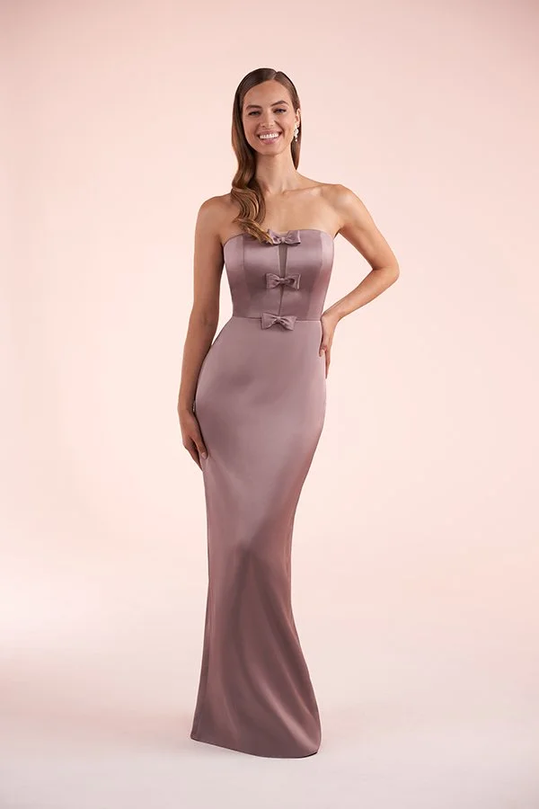 Woman modeling a mauve bridesmaid dress featuring a strapless sweetheart neckline, sleek column silhouette, and elegant bow detailing on the bodice for formal occasions.