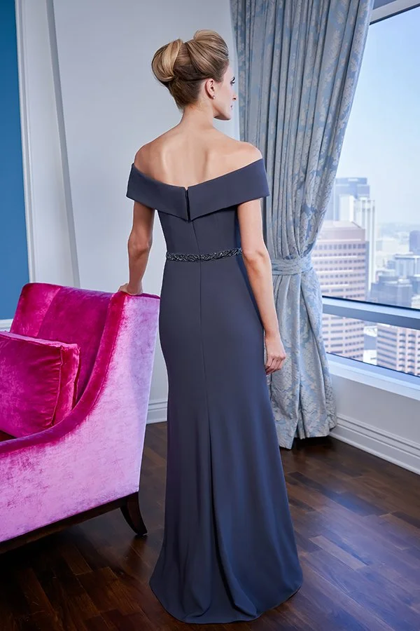 Back view of a slate blue mother of the bride gown with an off-the-shoulder neckline, sparkling beaded waistband, and a sleek floor-length column silhouette for weddings and formal occasions.