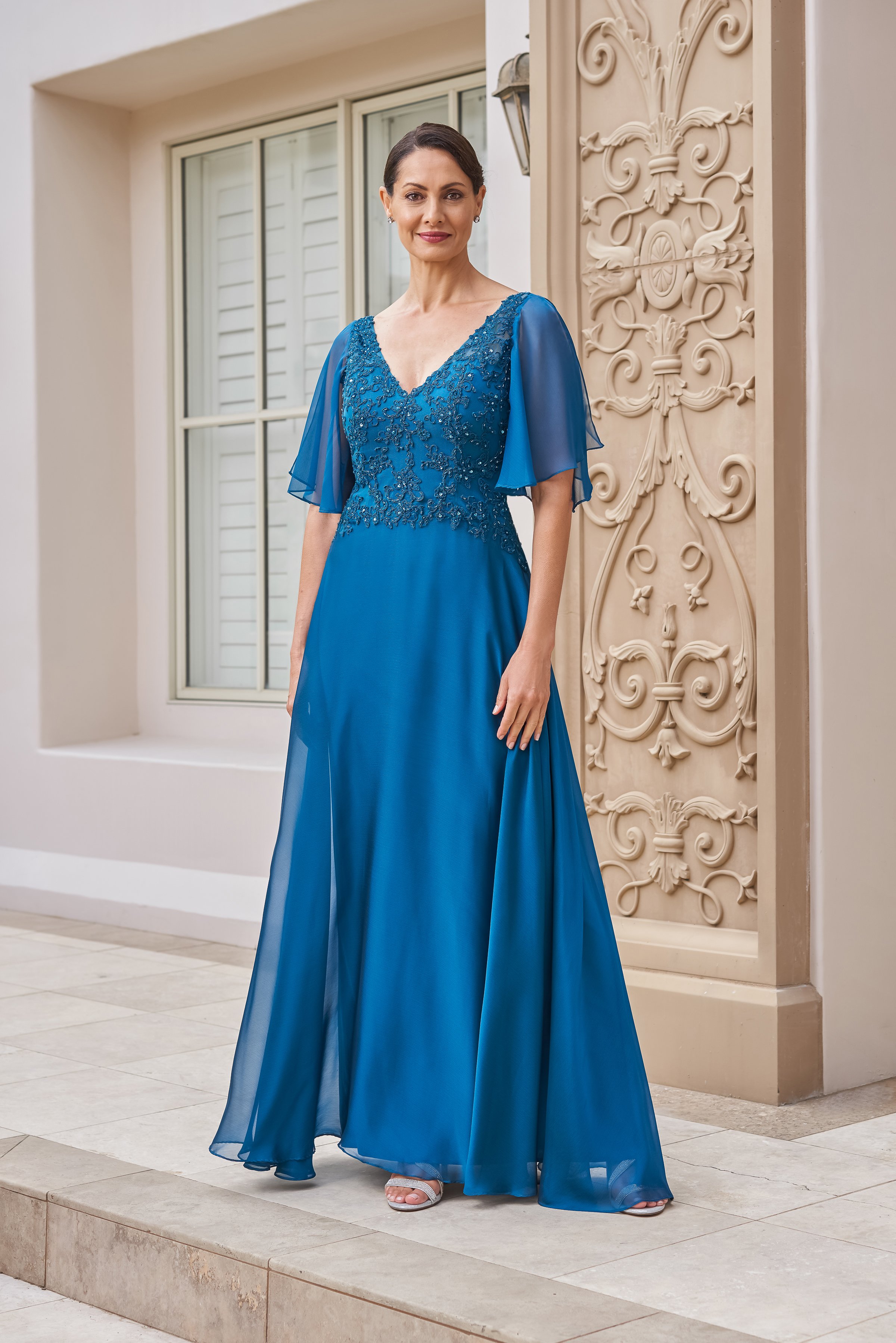 Front view of a teal mother of the bride gown with a beaded lace bodice, flattering V-neckline, sheer flutter sleeves, and a flowing chiffon skirt ideal for weddings and formal events.