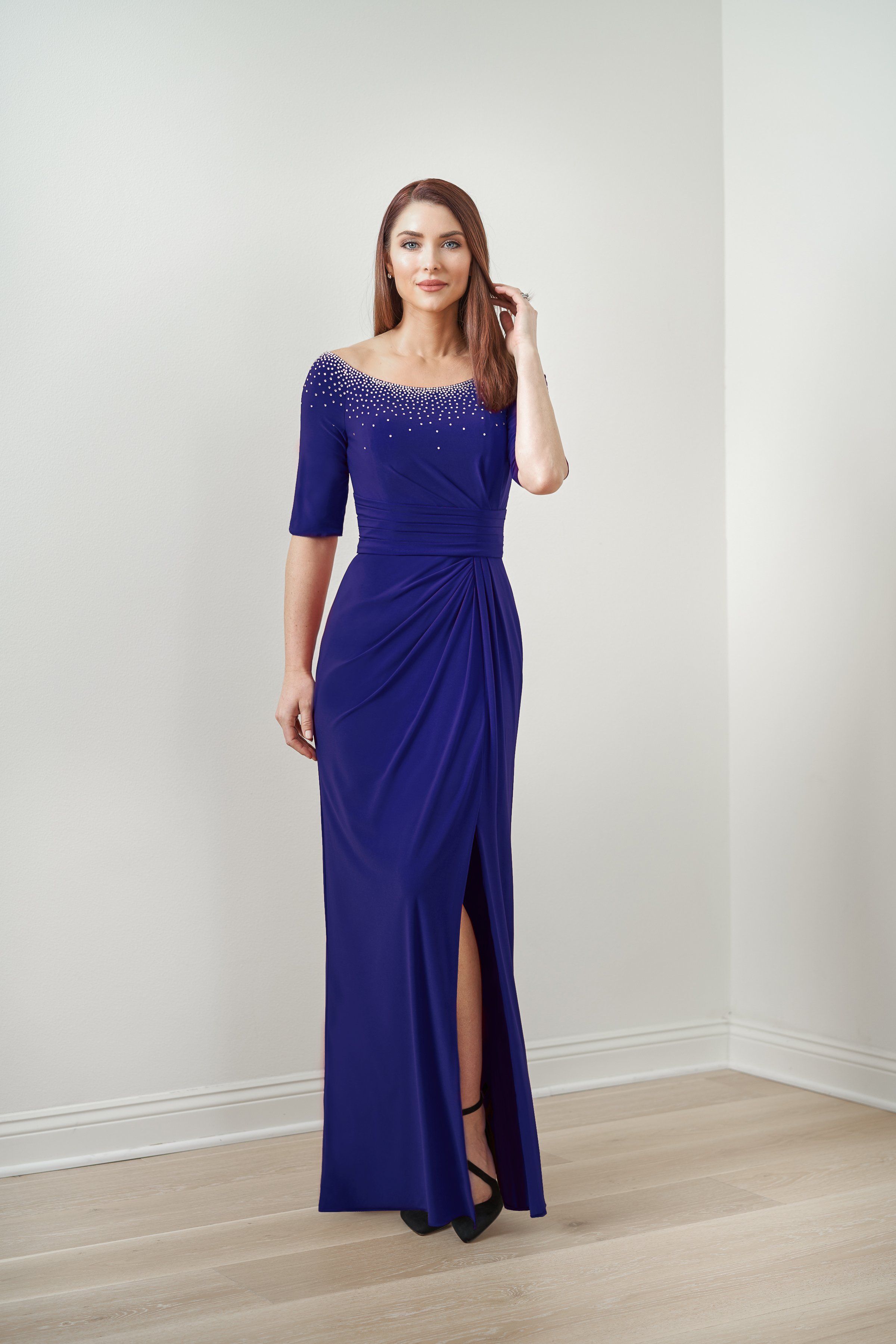 Front view of a royal blue mother of the bride gown with a sparkling beaded neckline, elbow-length sleeves, flattering ruched waist, and a front slit for weddings and formal events.