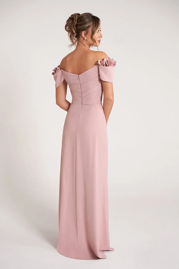 Back view of an elegant dusty rose mother of the bride gown featuring an off-the-shoulder neckline, floral shoulder embellishments, a softly draped bodice, and a graceful floor-length silhouette for formal occasions.