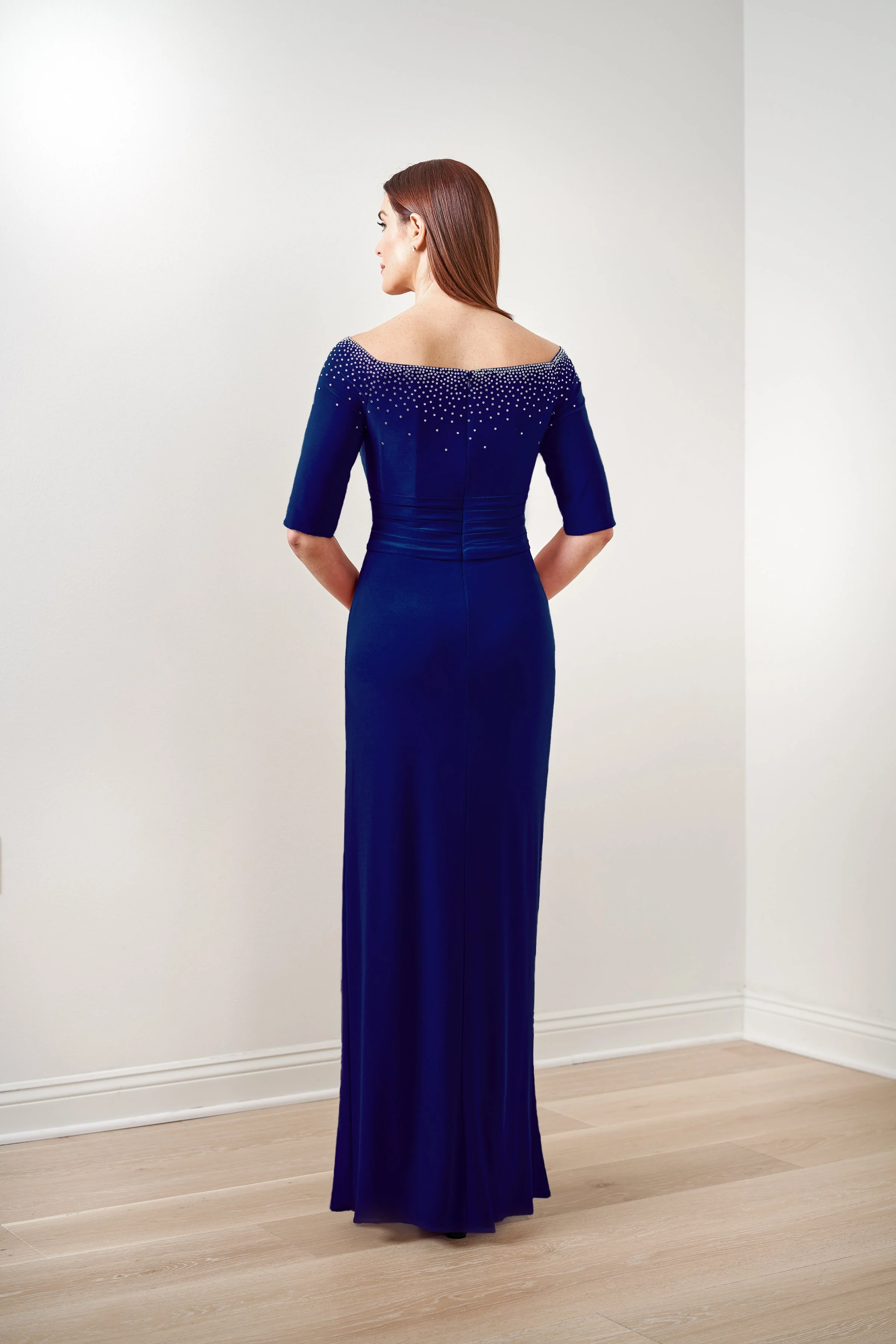 Front view of a royal blue mother of the bride gown with a sparkling beaded neckline, elbow-length sleeves, flattering ruched waist, and a front slit for weddings and formal events.