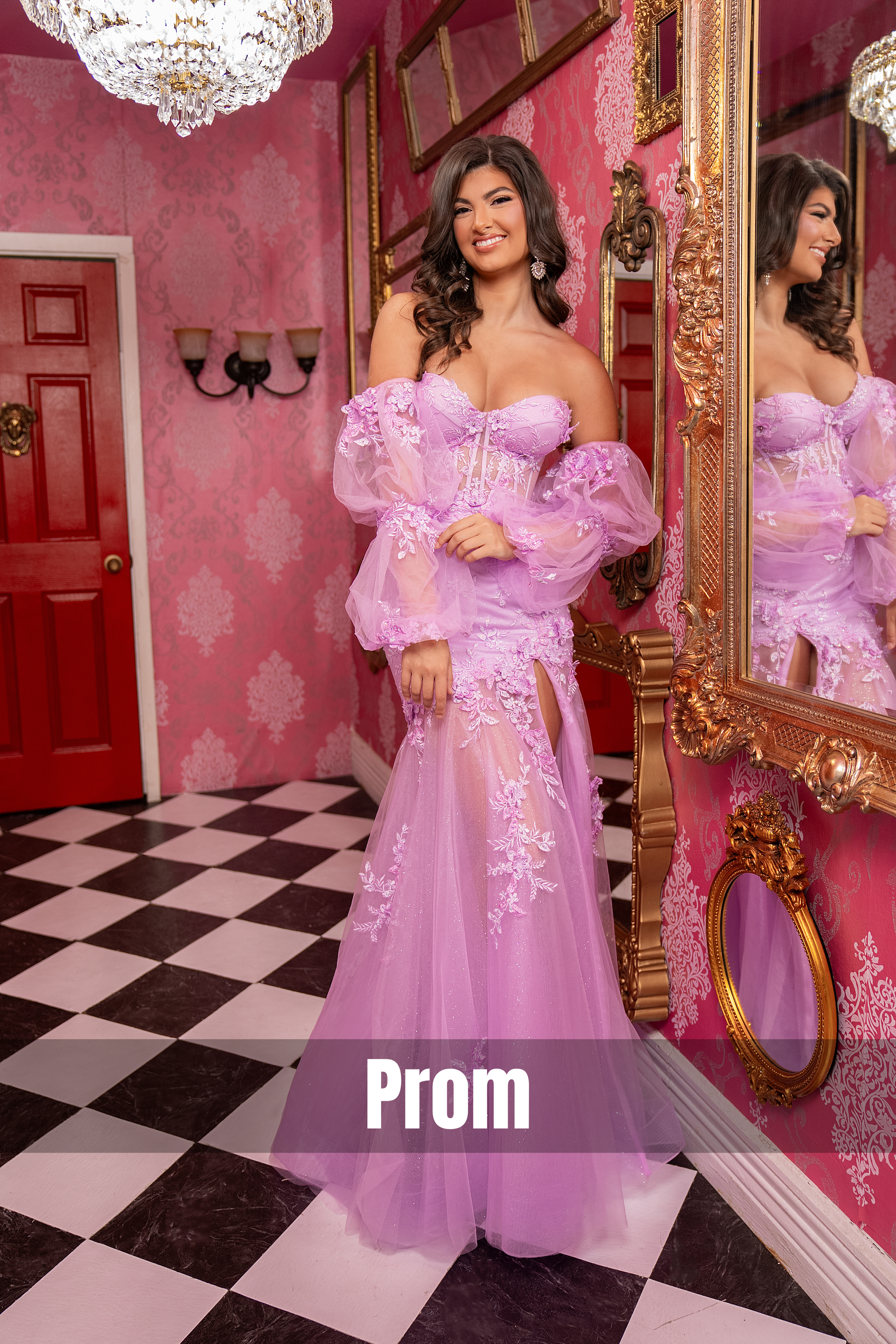 Model showcasing a lilac prom gown featuring floral lace appliqué, a structured corset bodice, sheer puff sleeves, and a high slit, styled in a luxurious pink interior with ornate gold décor.