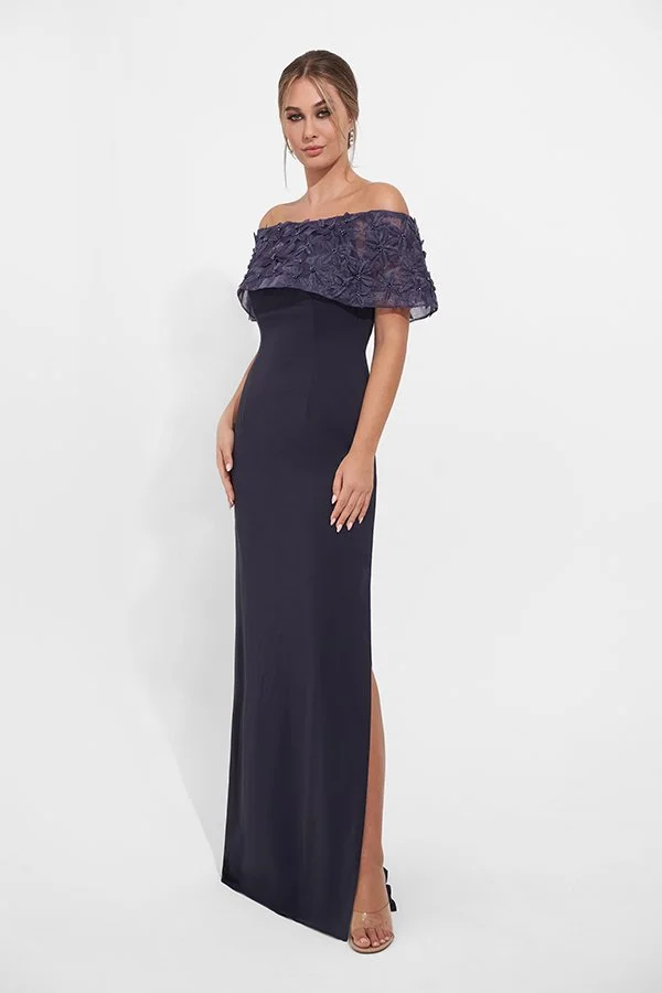 Front view of an elegant navy mother of the bride gown with an off-the-shoulder floral appliqué neckline, fitted silhouette, and side slit for weddings and formal occasions.