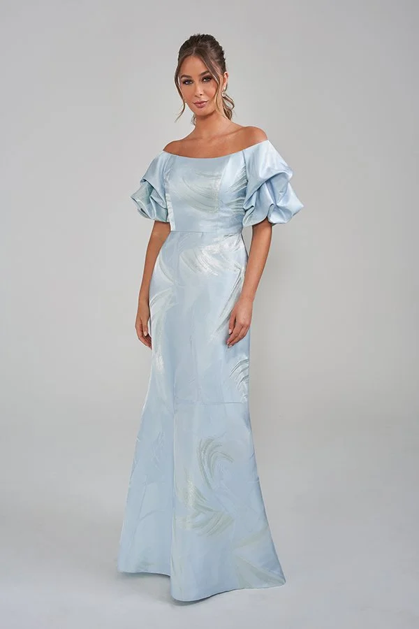 Elegant ice blue mother of the bride gown featuring an off-the-shoulder neckline, statement puff sleeves, a subtle metallic floral jacquard pattern, and a flattering floor-length silhouette for formal occasions.