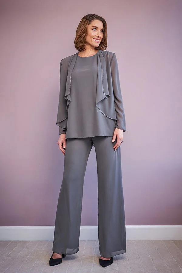 Woman modeling a charcoal mother of the bride trouser suit featuring wide-leg chiffon trousers, a layered tunic top, and an elegant waterfall-style jacket for special occasions.