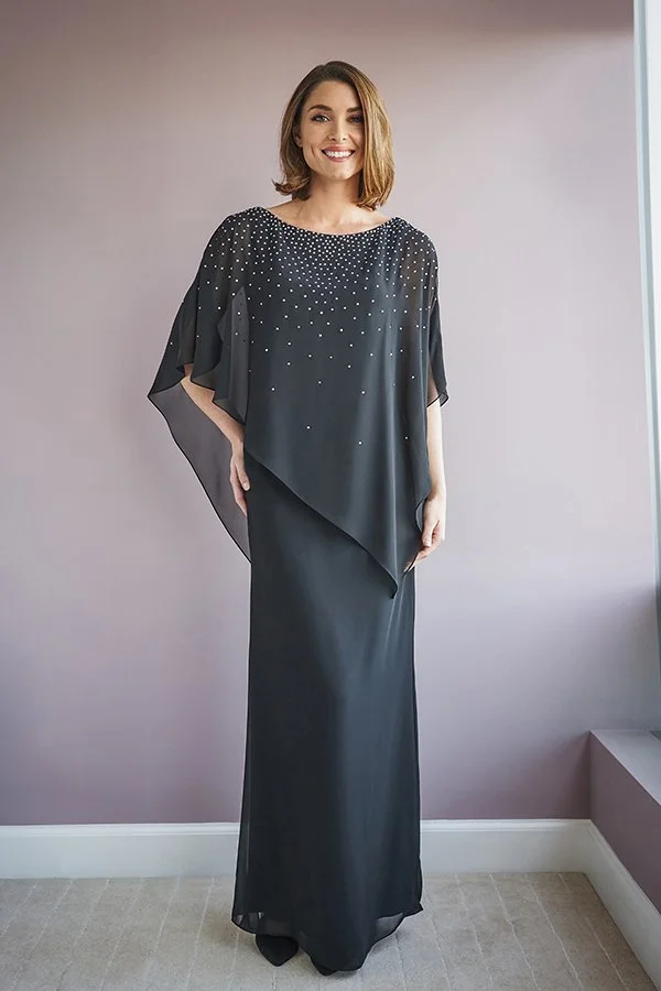 Woman modeling a black mother of the bride gown featuring a flowing chiffon cape overlay, sparkling bead embellishments, and an elegant floor-length column silhouette.