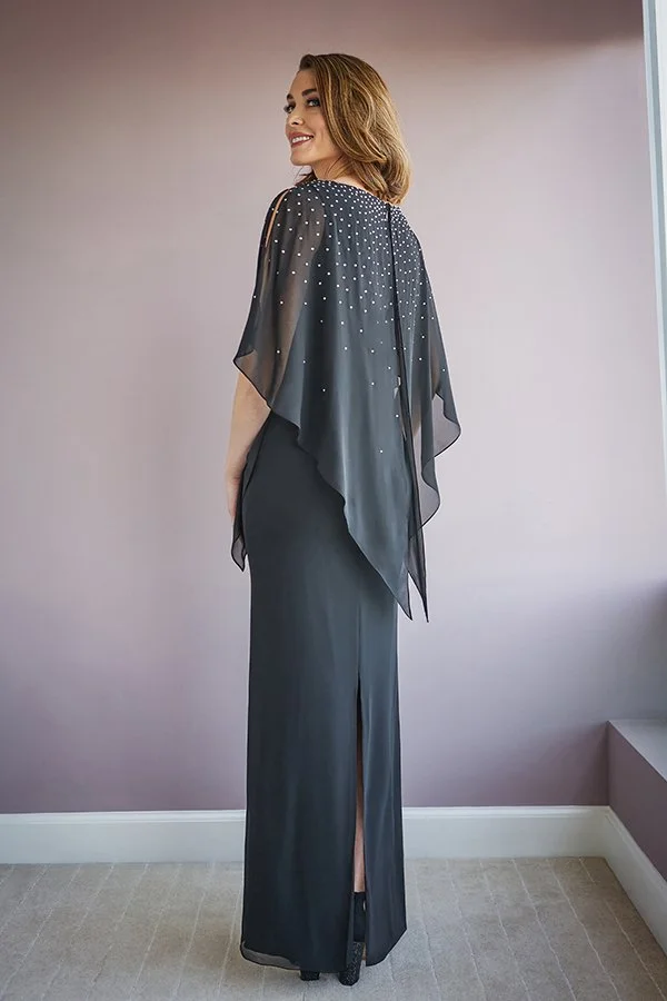 Back view of a black mother of the bride gown featuring a flowing chiffon cape overlay, sparkling bead embellishments, elegant column silhouette, and center back slit detail.