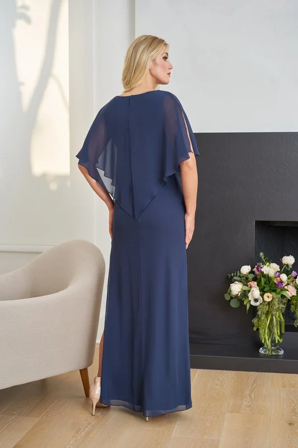 Back view of a dusty blue mother of the bride gown with a soft chiffon overlay, sheer flutter sleeves, elegant draping, and a floor-length skirt with a subtle side slit for formal occasions.