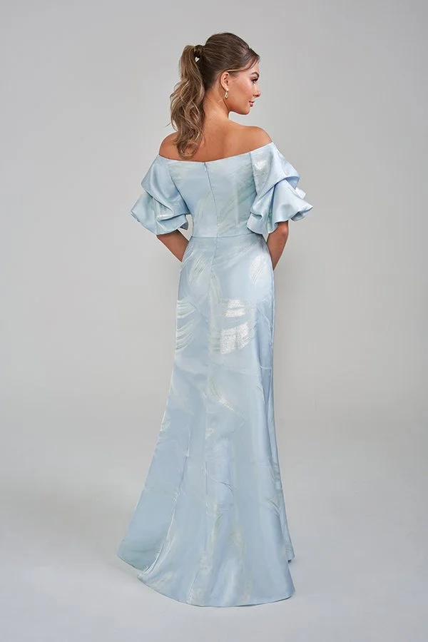 Back view of an elegant ice blue mother of the bride gown featuring an off-the-shoulder neckline, statement puff sleeves, subtle metallic floral jacquard detailing, and a sleek floor-length silhouette for formal occasions.