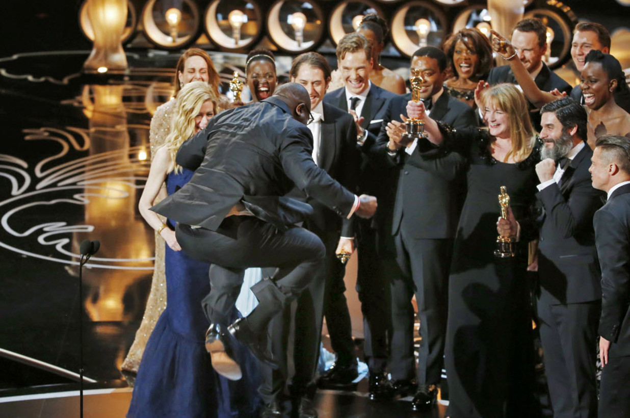 Photo Credit: Reuters - Steve McQueen jumps with joy after accepting the Oscar for Best Picture for his work on "12 Years a Slave"