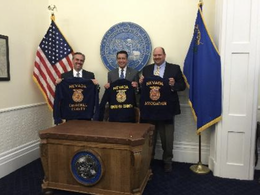 Nevada Strategies partners celebrating in front of Nevada seal