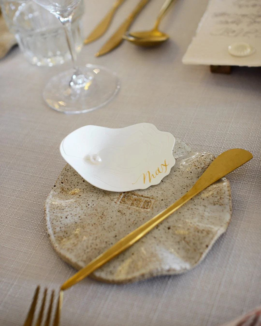 sculptural-3d-oyster-placecard-gold-calligraphy.jpg