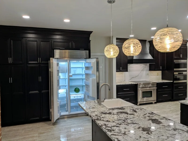 Rosehill Classic Contrast, moved island and rearanged entire kitchen adding a sink, lighting and large format tile.  A dark disfunctioning kitchen was turned into a bright flowing space to prepare meals and gather.