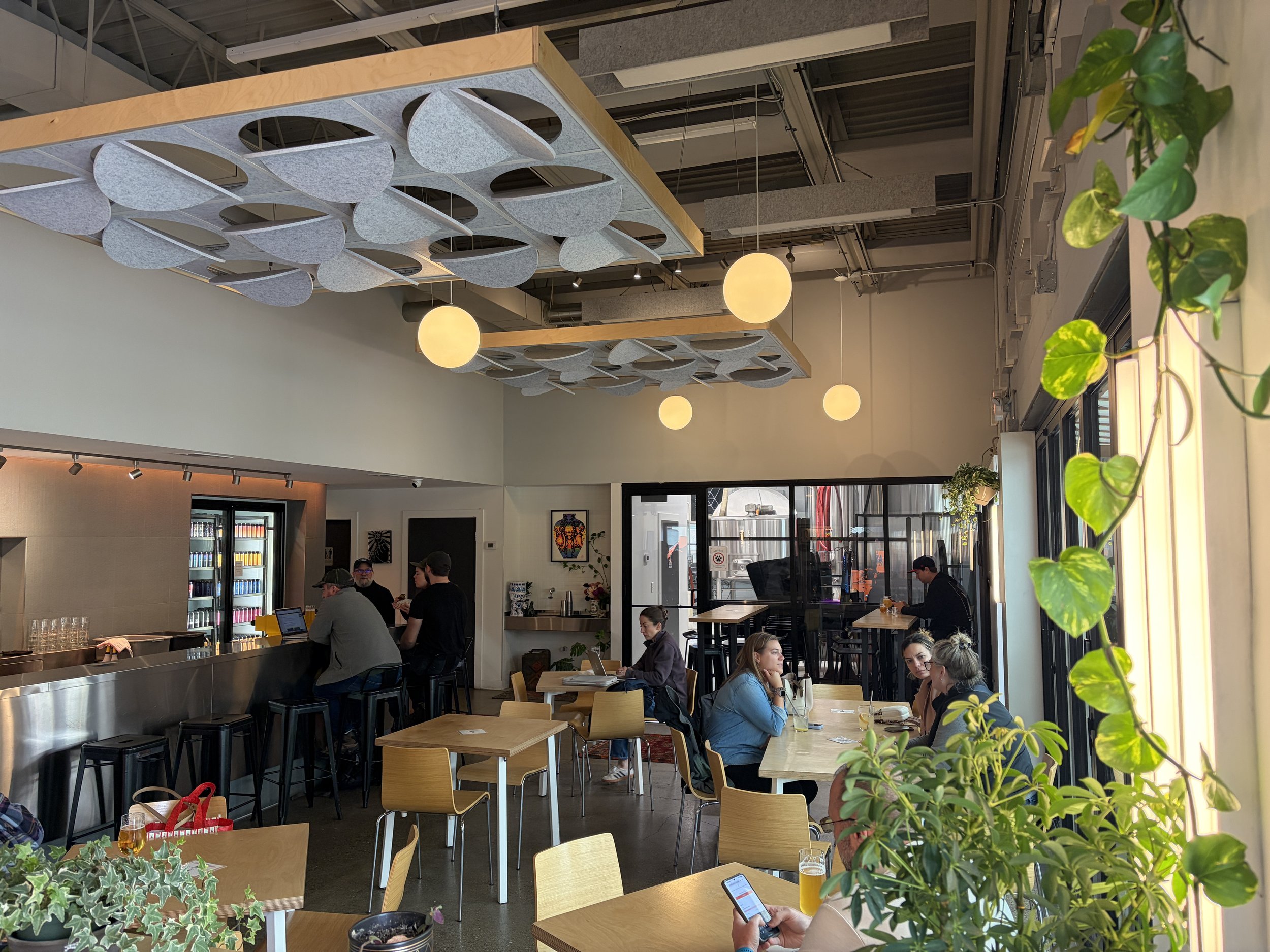 An image of Mothfire taproom with the installed Leon x Askia Acoustic Island with an oak frame and Luna tiles in heather grey