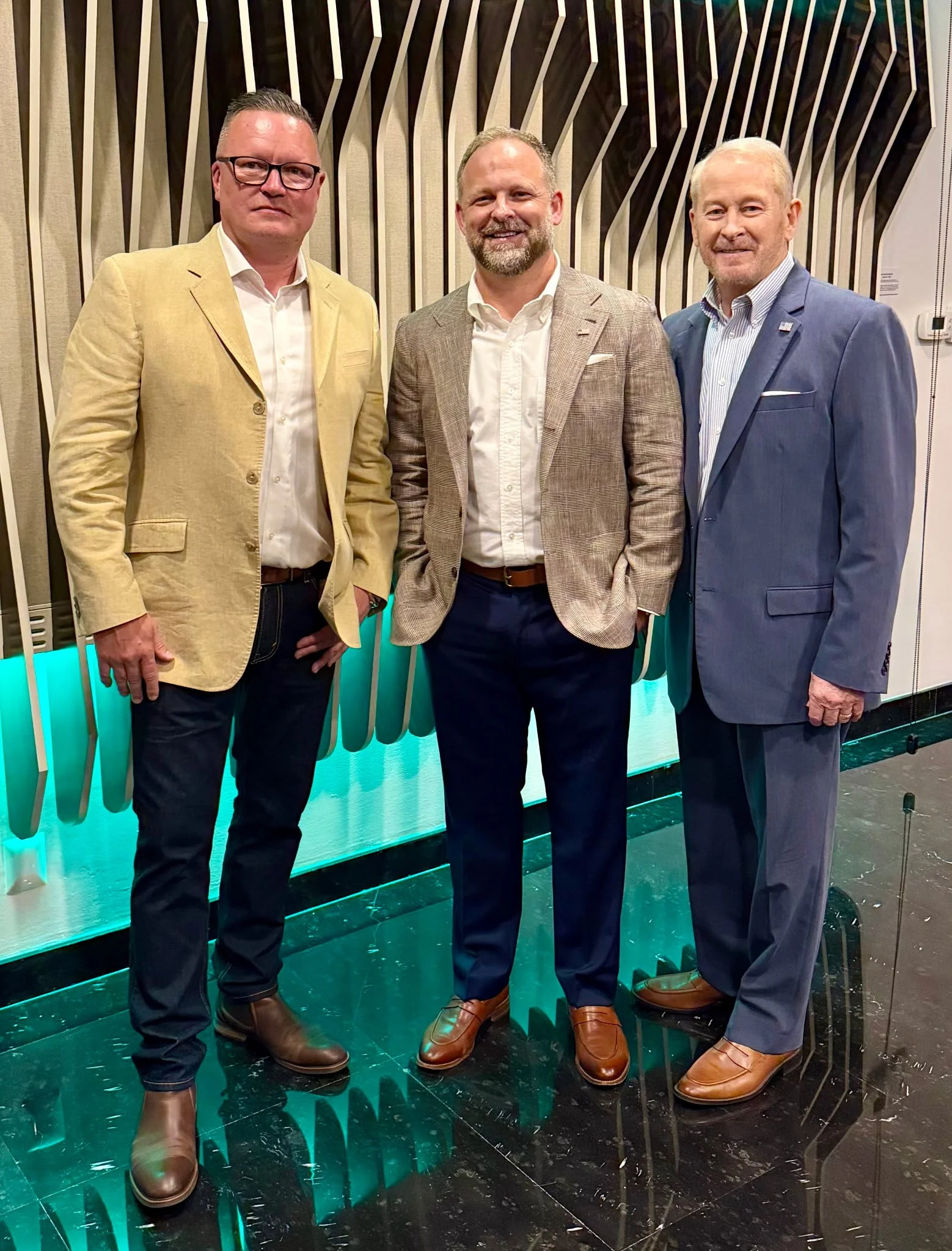 Robert Waissi, Michael Johnson, and US Ambassador to Mexico Ronald Johnson stand in front of Sculptura in the Mexican Ambassador's residence.