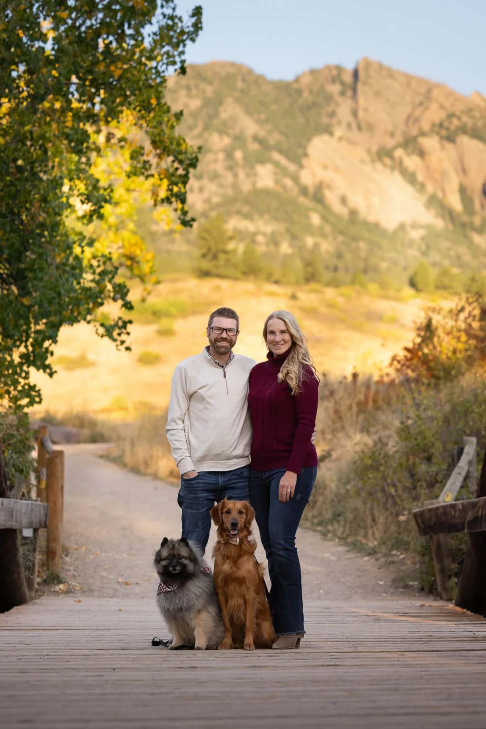Couple poses with their dogs for a portrait during a dog photography session at South Boulder Creek in Boulder, Colorado.