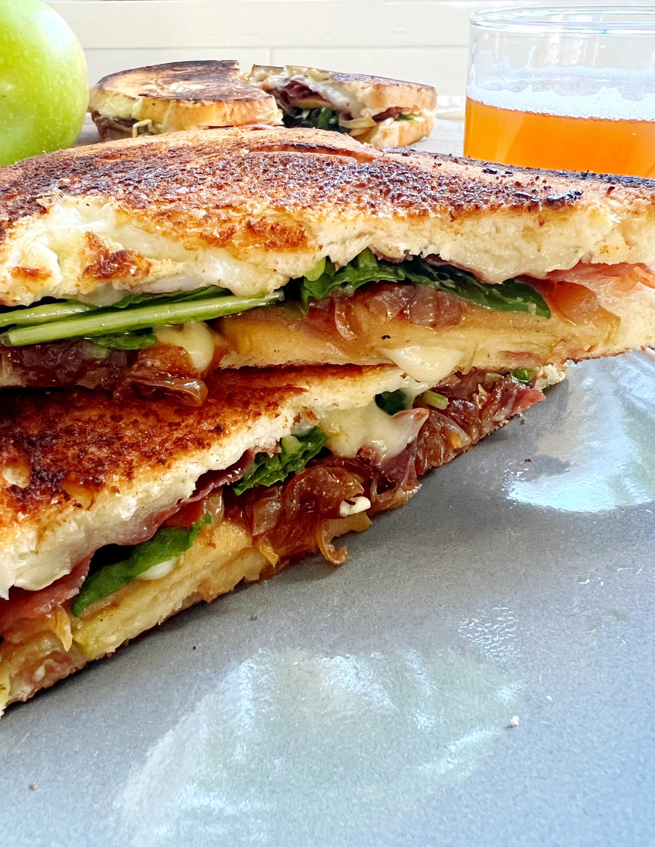 Beer Sautéed Apple, Caramelized Onion, Brie, Crispy Prosciutto and Arugula Sandwiches